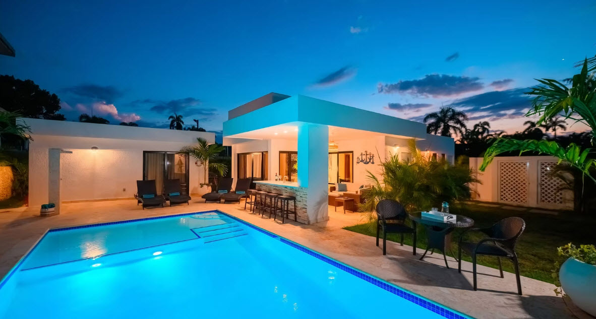 Modern villa with pool and bar at dusk