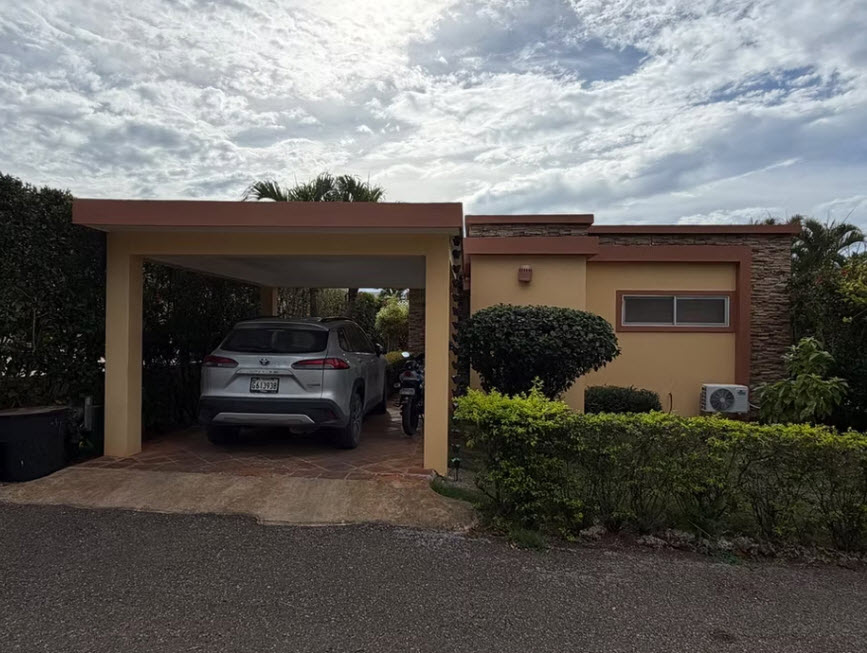 Modern single-story home with carport and silver SUV