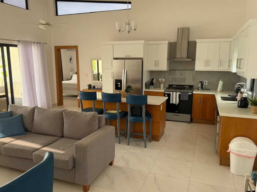 Modern open-plan living and kitchen area with island seating