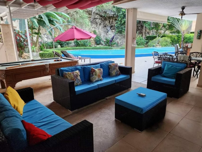 Outdoor patio with pool, lounge furniture, and pool table