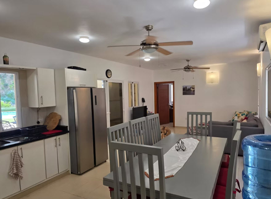 Spacious open-plan kitchen and dining area with modern appliances and furniture.