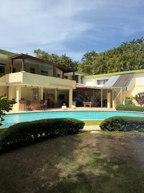 Luxury villa with a large pool and lush tropical landscaping