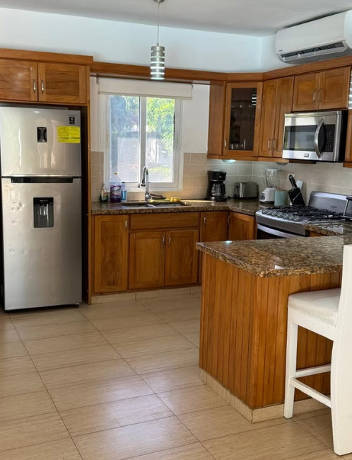 Modern kitchen with stainless steel appliances and granite countertops