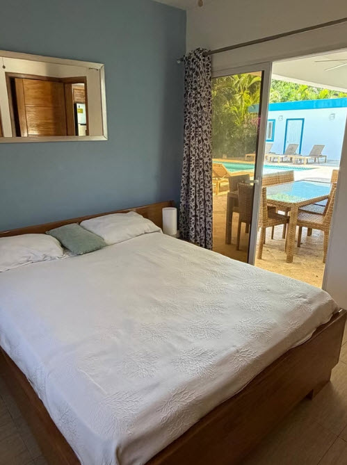 Bedroom with a view of a pool and patio area