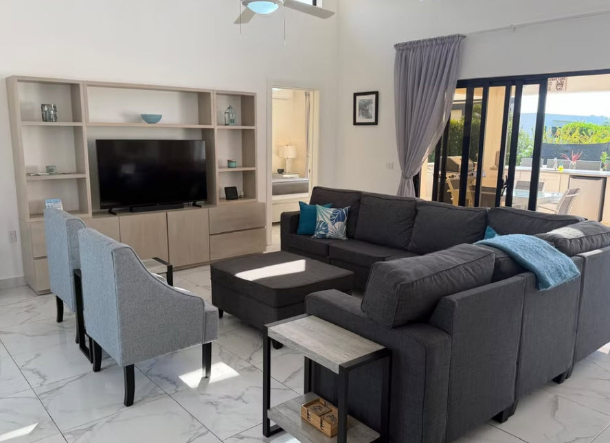 Spacious modern living room with large sectional sofa and entertainment center
