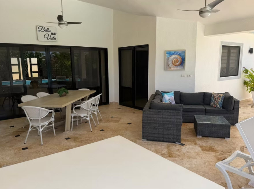 Outdoor patio with dining table, chairs, and sectional sofa