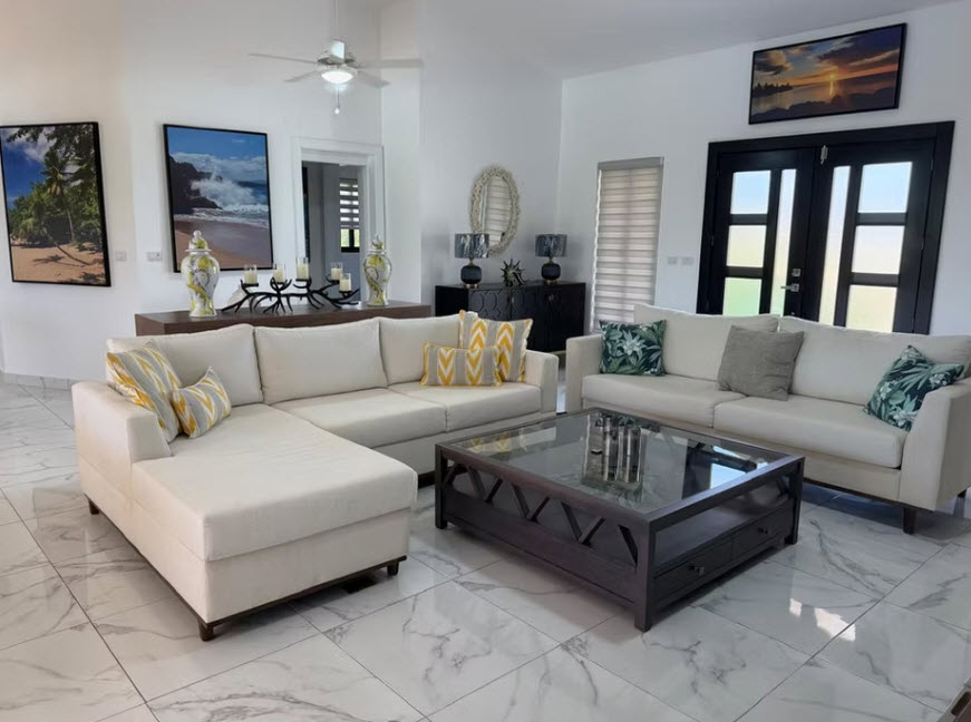 Modern living room with sectional sofa, coffee table, and abstract art