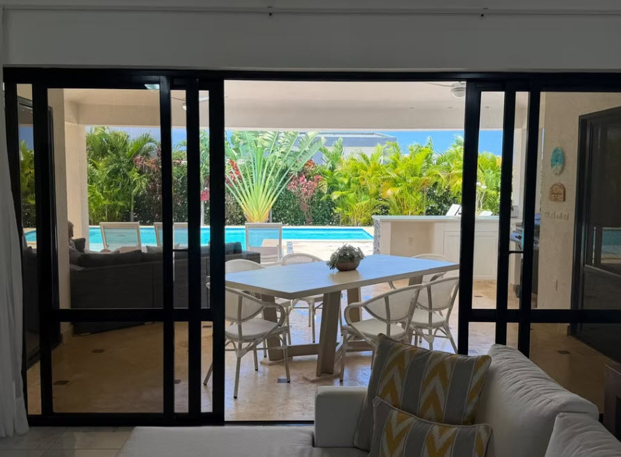 Luxury Caribbean villa with private pool, outdoor dining, and tropical landscaping.