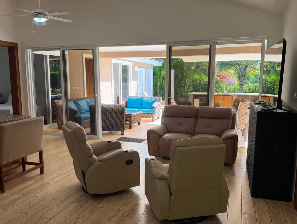 Living room with comfortable recliners, sectional sofa, and patio view
