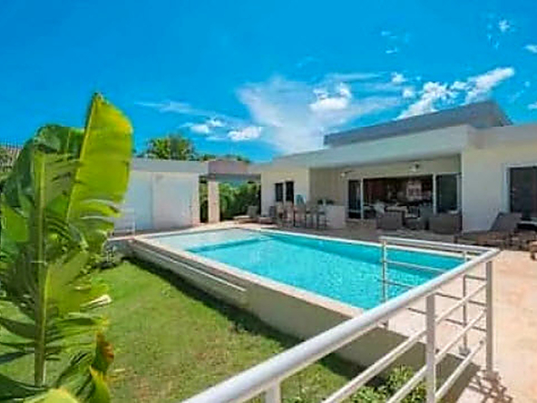 Luxury villa with private pool and tropical plants, perfect for a Caribbean vacation.