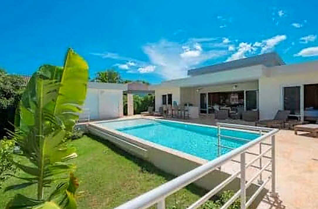 Luxury villa with private pool and tropical plants, perfect for a Caribbean vacation.