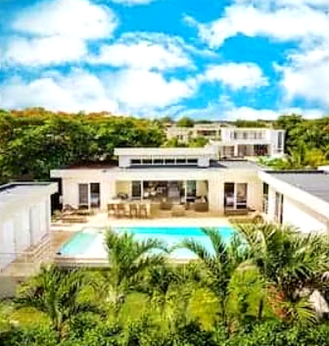 Modern villa with pool and lush tropical landscaping