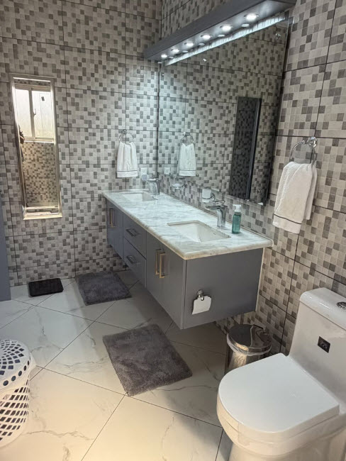 Modern grey double vanity bathroom with mosaic tile and marble countertop