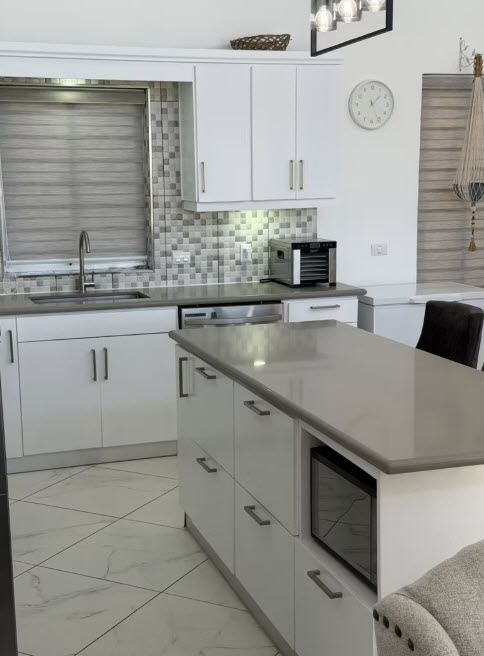 Modern white kitchen with grey countertops and island