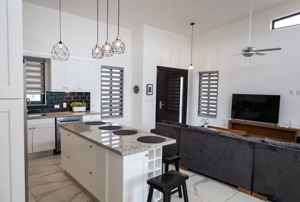 Modern open-plan living and kitchen area with island and sectional sofa