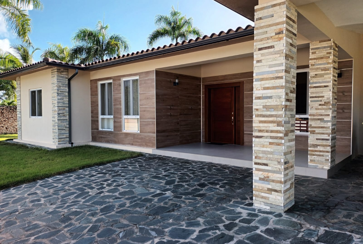 Modern house with stone accents, wood siding, and stone driveway