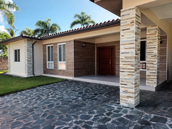 Modern house with stone accents, wood siding, and stone driveway