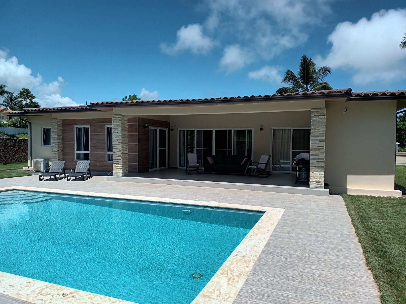Modern house with swimming pool and outdoor patio furniture