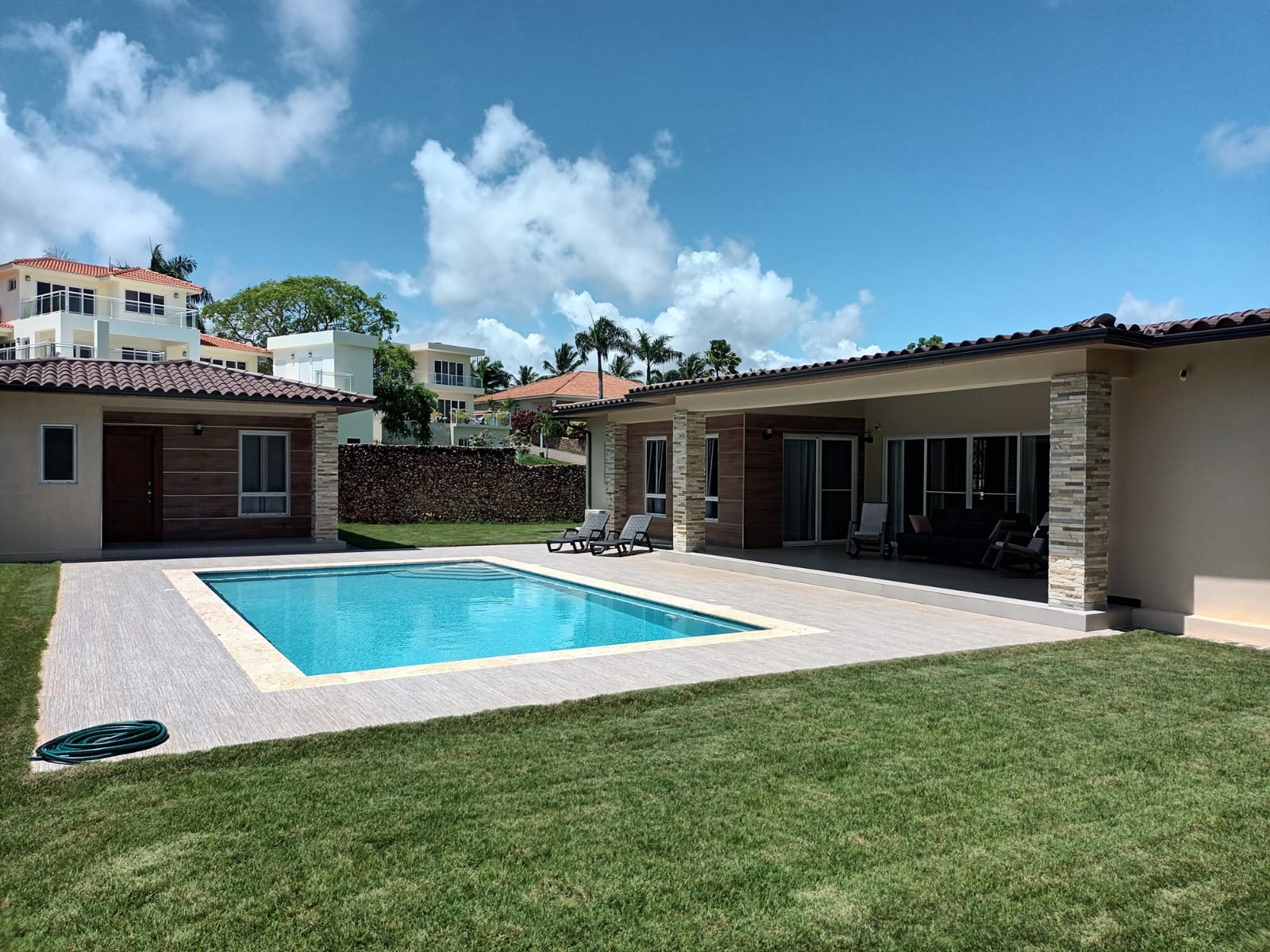 Modern luxury villa with swimming pool and outdoor lounge area