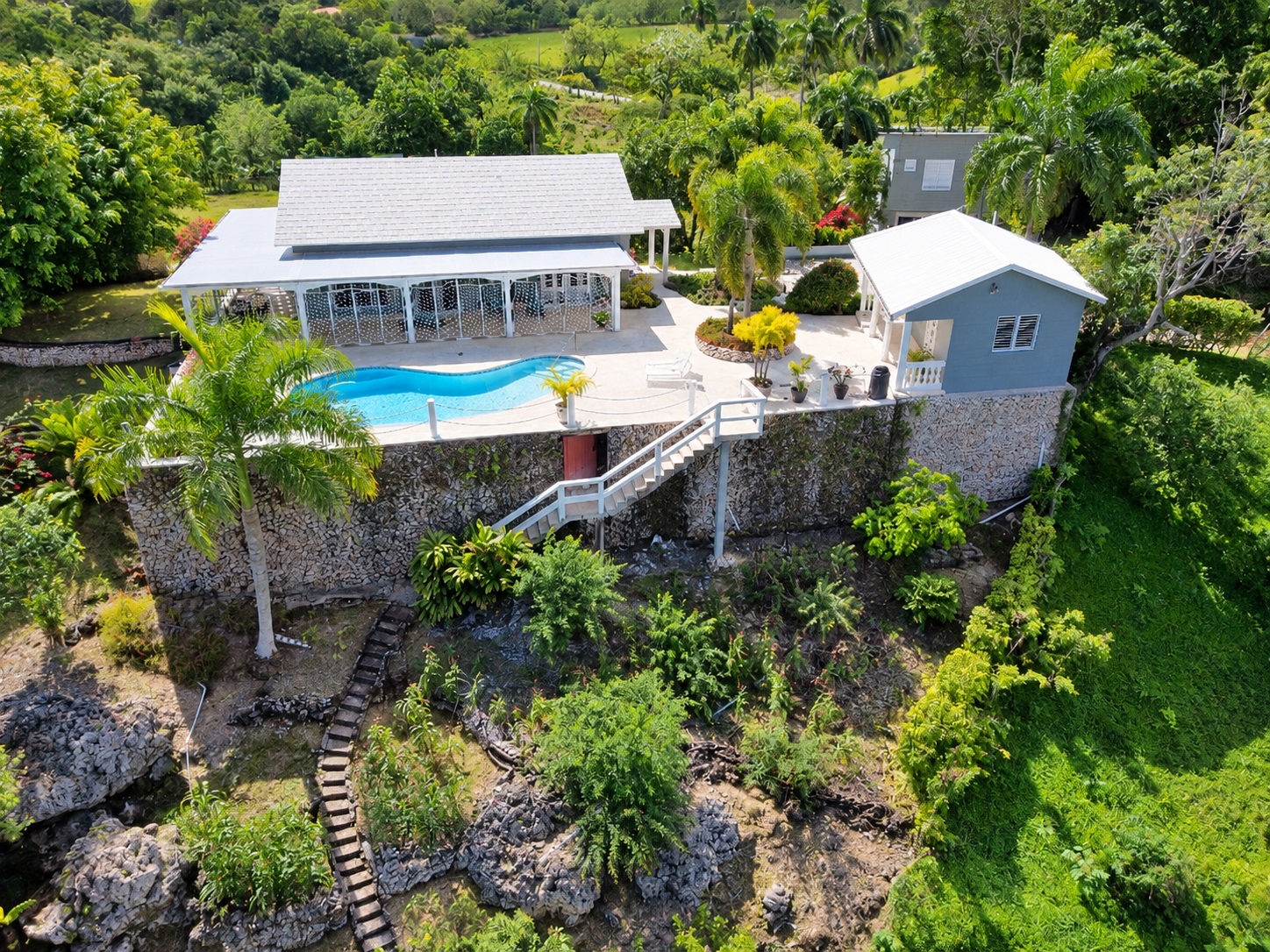 Luxury villa with a swimming pool and lush tropical landscaping